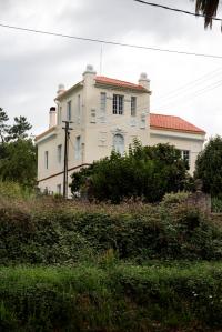 Poco antes del puente de O Pedrido encontramos este suntuoso palacete custodiado por tres palmeras canarias. Separada de la carretera por la amplia finca y un artístico muro, la vivienda se dispone en planta rectangular, sobresaliendo ligeramente de la fachada principal el torreón situado en el ángulo Este.